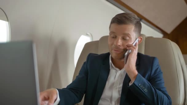 Happy mature businessman talk by phone partner connection aircraft jet travel - Footage, Video
