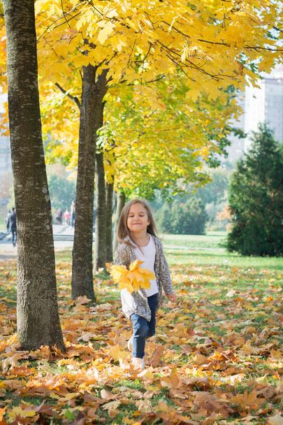 Happy girl run in autumn park - Фото, изображение