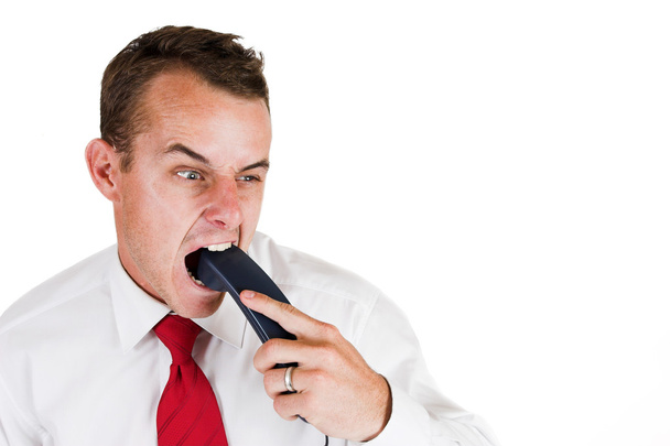 Businessman biting the telephone - Фото, зображення