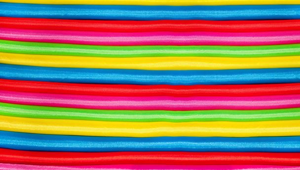 Beautiful bright multicolored silk fabric folded. Colorful background wallpaper. - Photo, Image