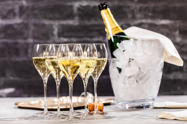 Bottle of champagne and filled glasses decorated in festive theme - Foto, Imagen