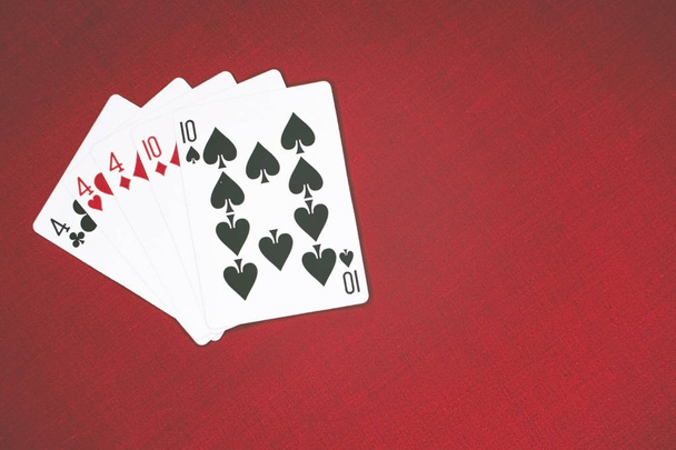 Cards for Poker on a red background, full house. - Photo, Image