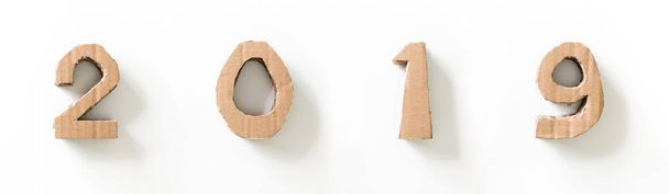 2019, números 3D hechos a mano de papel de cartón reutilizado, sobre fondo blanco
. - Foto, Imagen