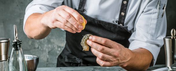 Chef cooking with Tiger prawn on dark background  - Фото, изображение
