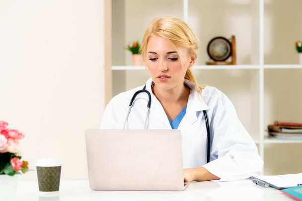 Young female doctor working in hospital office. Medical and healthcare concept. - Photo, Image