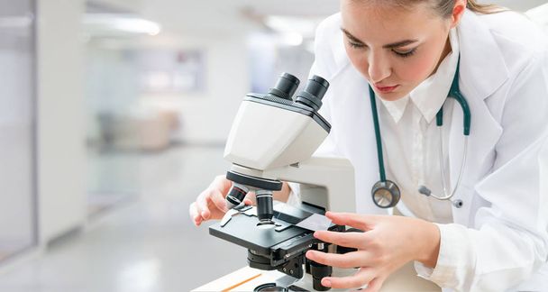 Scientist researcher using microscope in laboratory. Medical healthcare technology and pharmaceutical research and development concept. - Valokuva, kuva