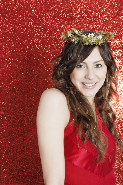 Young attractive woman wearing a gold tinsel tiara - Photo, Image
