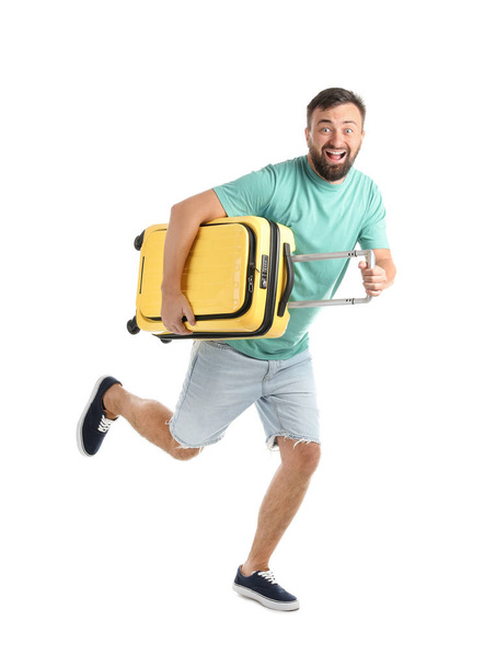 Man with suitcase running on white background. Vacation travel - Valokuva, kuva