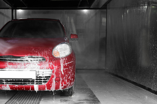 Cleaning auto with high pressure water jet at car wash - Fotografie, Obrázek