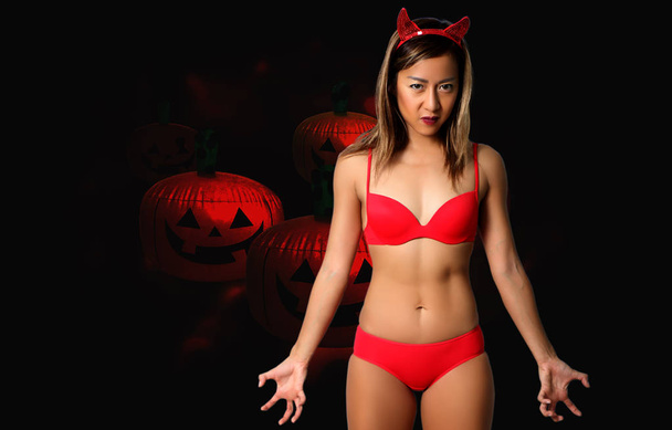 sexy devil woman in red bikini and halloween - 写真・画像