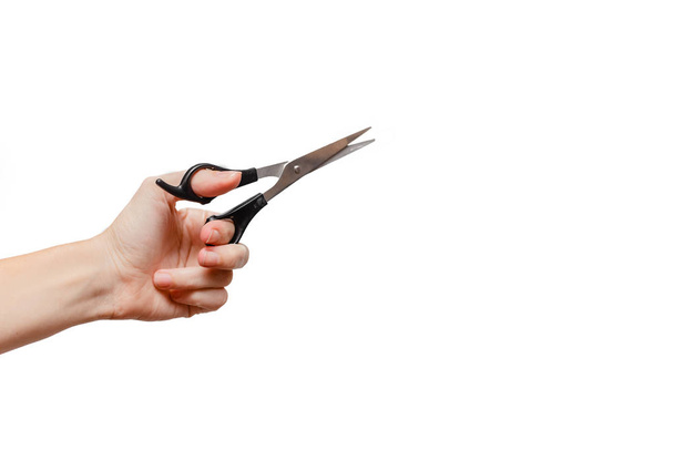 Female hand holding scissors. Stationary  Concept. White background, isolated, close up  - Fotografie, Obrázek