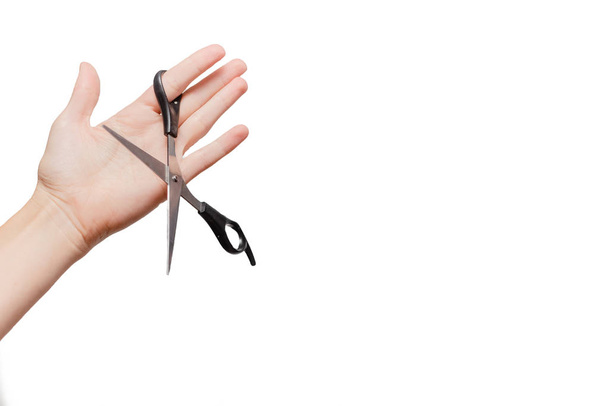 Female hand holding scissors. Stationary  Concept. White background, isolated, close up  - Photo, Image