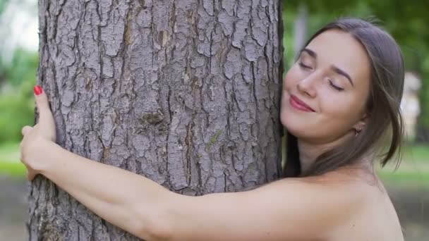 Pretty woman hugs a tree, feels oneness with nature, love of life, unity outdoor - Záběry, video