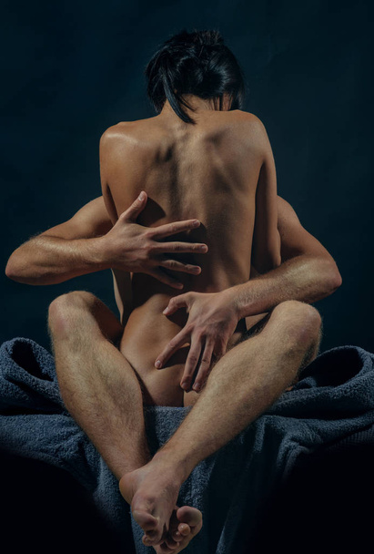 Girl and guy posing naked. Passion and sensual touch. Naked woman and young man having sex. Sensual Kiss. Concept of sensual and intimate moment of lovers. Orgasm concept. - 写真・画像