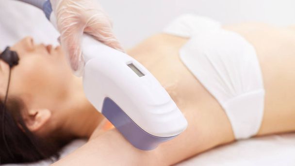 Hair laser removal service. IPL cosmetology device. Professional apparatus. Woman soft skin care.armpit - Фото, изображение