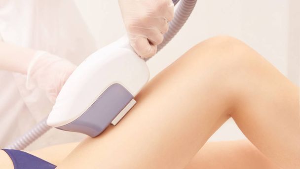 Hair laser removal service. IPL cosmetology device. Professional apparatus. Woman soft skin care.leg - Zdjęcie, obraz