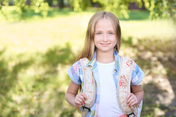 schoolchildren girl back to school. Happy girl smile with little backpack. - Φωτογραφία, εικόνα