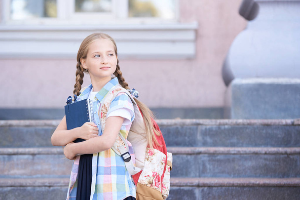 schoolchildren girl back to school. Happy girl smile with little backpack. - Foto, immagini