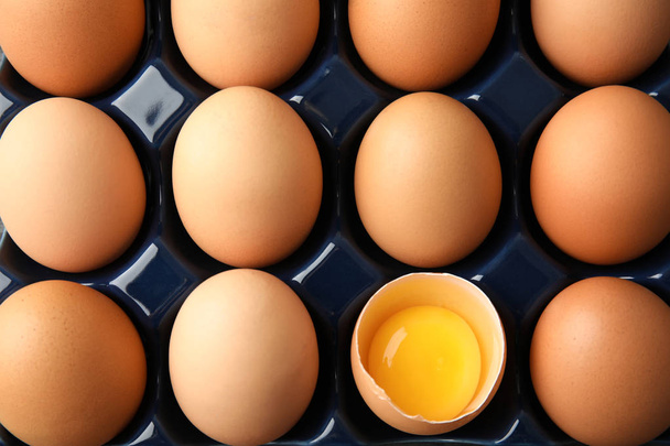 Raw chicken eggs in ceramic holder, top view - Foto, immagini