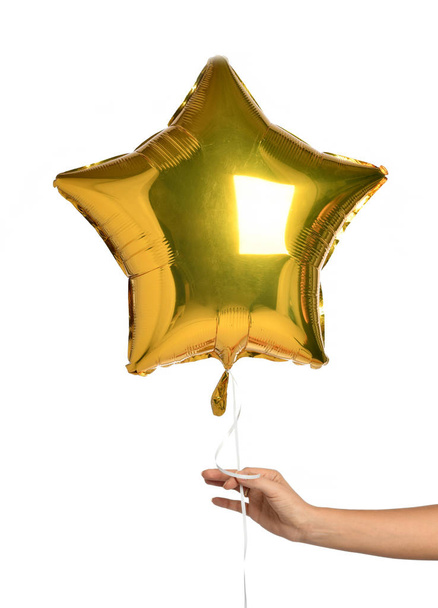 Woman hand hold gold star balloon for birthday party celebration isolated on a white background - Valokuva, kuva