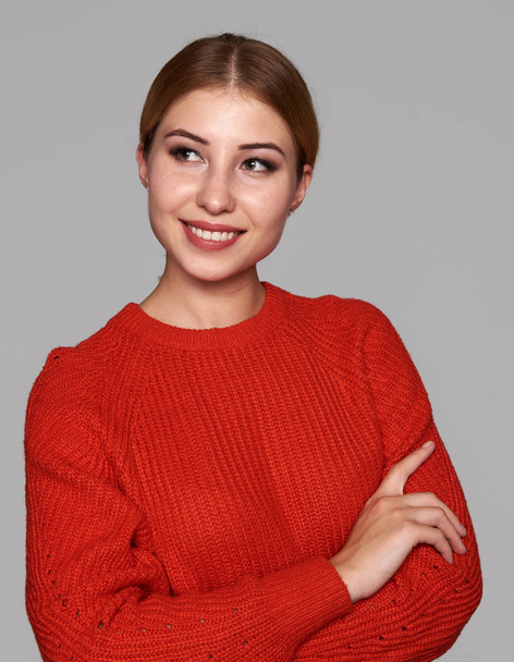 Beautiful caucasian woman wearing red sweater. Isolated on gray studio background - Фото, зображення