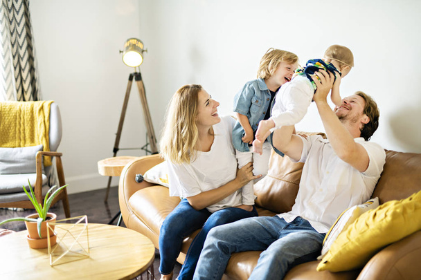 Family having fun on sofa. - Фото, зображення