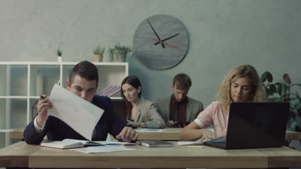 White-collar workers doing routine job in office - Materiał filmowy, wideo