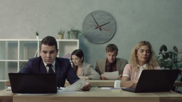 Bothersome employee distracting coworker from work - Materiał filmowy, wideo