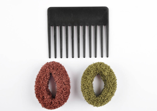 Comb and bobbles on white background - Photo, Image