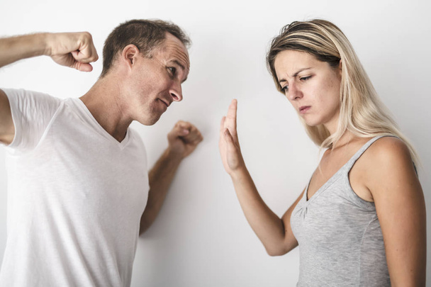 man beating helpless woman at home white background - Foto, Imagen
