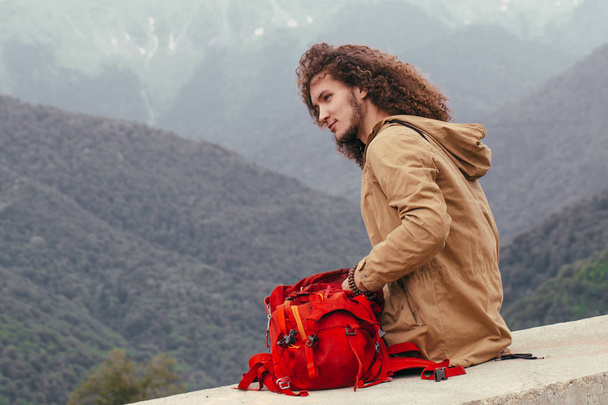 man Packing Backpack for hiking with mountains on background - Foto, imagen