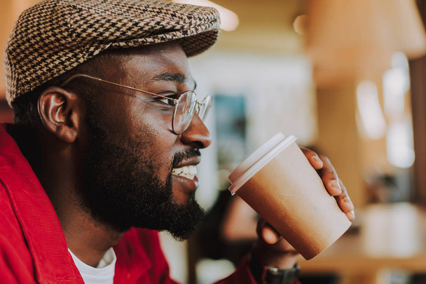 Close up of bearded man smiling and drinking coffee - Fotoğraf, Görsel