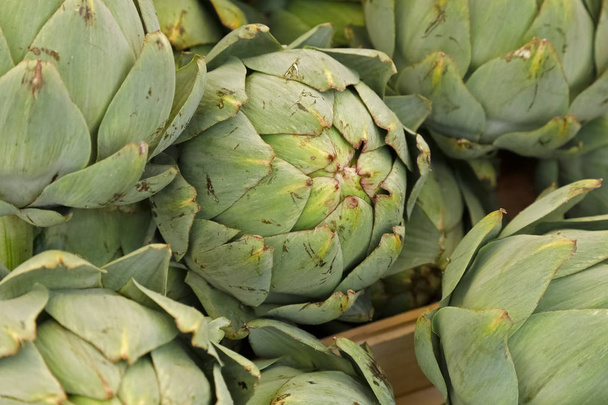 Fresh artichokes put up for sale at farmers market. - Photo, Image