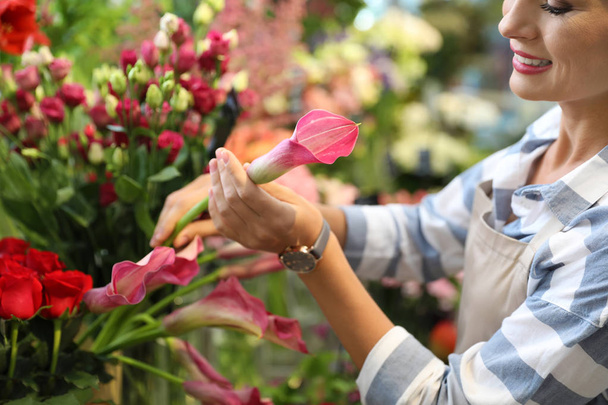 Female florist working in flower shop, closeup - 写真・画像