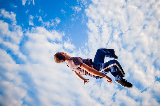 Man trains parkour while jumping in the air - Photo, Image