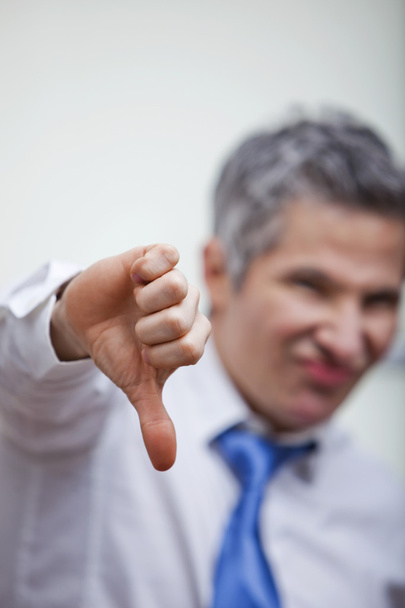 Businessman gesturing thumbs down sign - Photo, Image