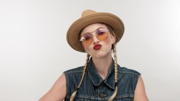 models in hat with two braids and glassess, looks like a cowboy girl - Materiaali, video