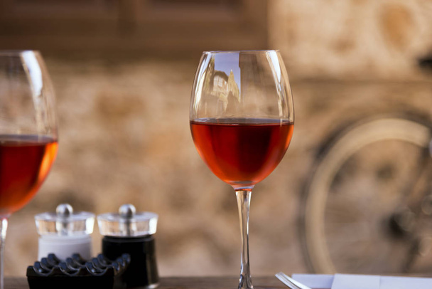 Red wine in a wine glass on a table - Φωτογραφία, εικόνα