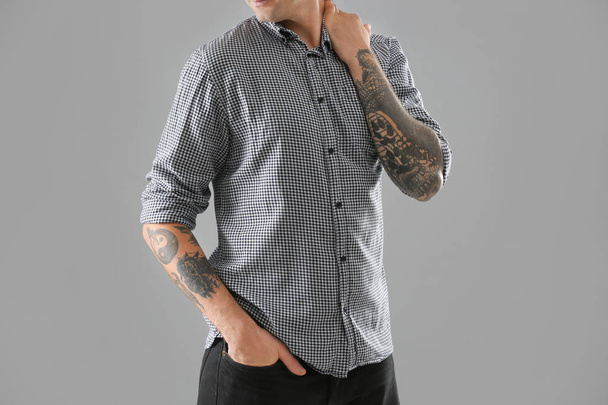 Young man with stylish tattoos on white background - Fotoğraf, Görsel