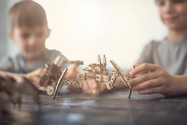 Close up of creative children making wooden figures together - Φωτογραφία, εικόνα