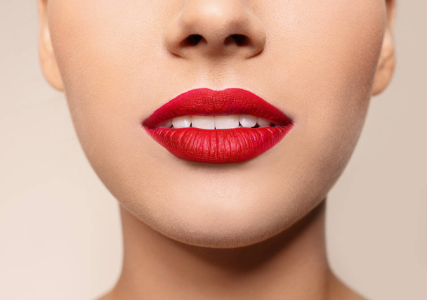 Beautiful young woman with red lips on color background, closeup - Valokuva, kuva