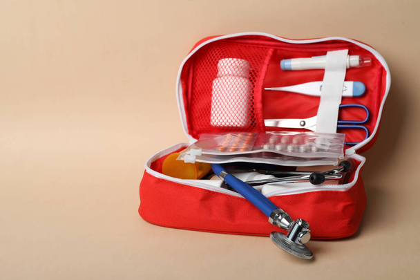 First aid kit on color background. Health care - Foto, afbeelding