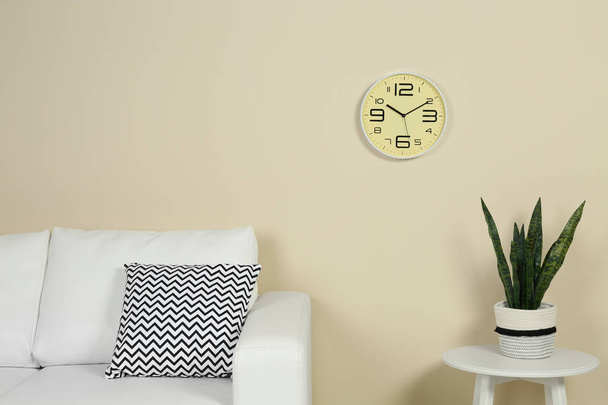 Living room interior with clock and space for text on wall. Time management - Foto, afbeelding