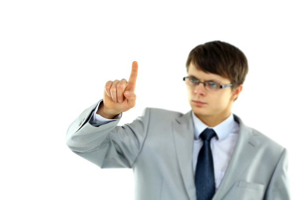 Young business man pointing at something isolated white background - Foto, Bild