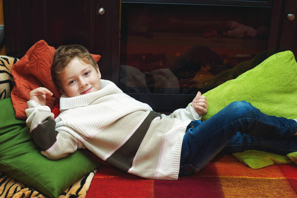Portrait of a boy in a warm sweater in the house . - Photo, Image