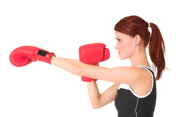 Sexy young adult Caucasian woman in a training wear with boxing gloves - Foto, imagen