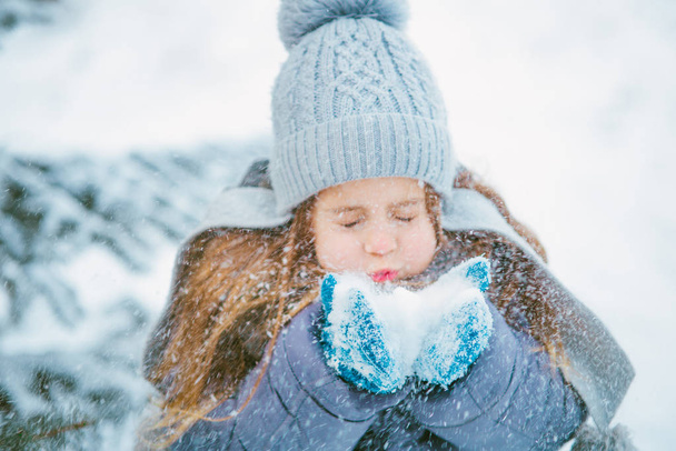 Cute little girl smiling and playing in winter with snow. - 写真・画像