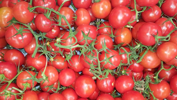 red and green tomatoes background in market for wallpaper - Photo, Image