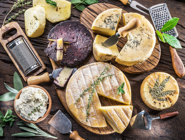 Homemade cheeses on the wooden background. Cheese background. - Foto, afbeelding