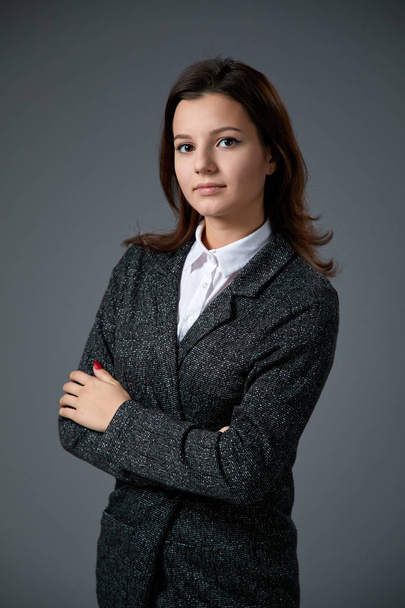 portrait of beautiful young woman wearing white shirt posing on grey background   - Fotografie, Obrázek